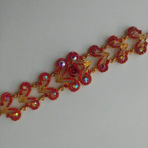 Statement gold tone and red glass crystal wide bracelet